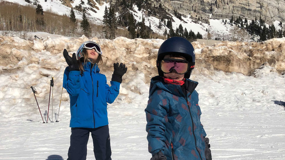 Two kids in ski gear on mountain